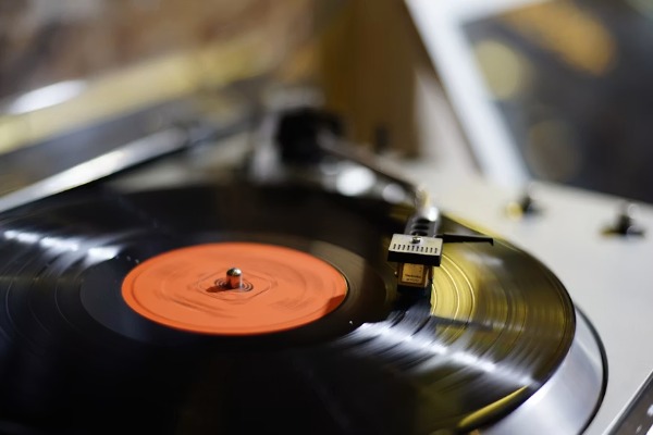 Close-up of a black vinyl record on a turntable.